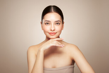 Portrait beautiful young woman with clean fresh skin. Model with healthy skin looks at an empty space, close up portrait. Cosmetology, beauty and spa