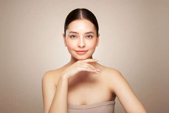 Portrait beautiful young woman with clean fresh skin. Model with healthy skin looks at an empty space, close up portrait. Cosmetology, beauty and spa