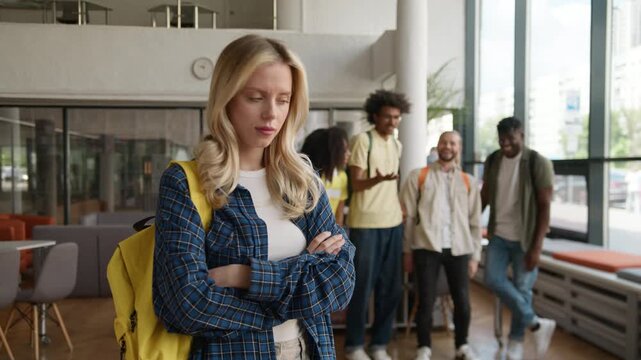 Caucasian woman frustrated with bullying by students mocking bully sad girl in university college school academy four multiethnic classmates laughing aggressive laugh education problem outcast lady
