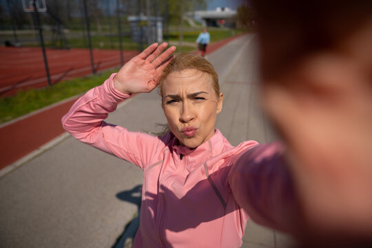 Female runner taking a selfie after exercising outdoors