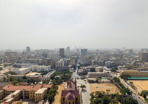 Aerial view of St. Patrick's Cathedral with its gothic revival architecture and the surrounding urban cityscape under a hazy sky in Karachi, Sindh, Pakistan.