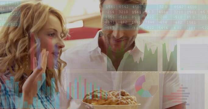 Holding tray, couple in white and blue gesturing at bakery counter, glazed pastries with charts