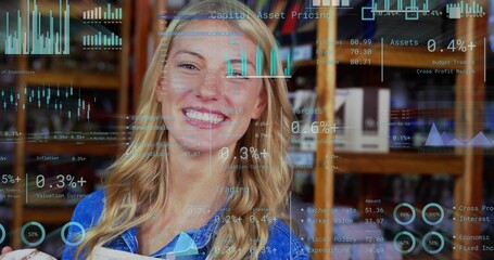 Fototapeta premium Smiling adult woman in blue collared shirt holding book and viewing financial charts at library