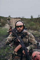 Fototapeta premium Portrait of Ukrainian soldier with rifle looking in he camera