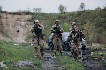 Fototapeta premium A group of Ukrainian soldiers covering a drone operator