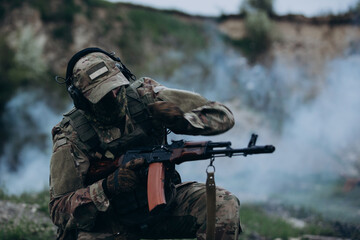 Fototapeta premium Ukrainian soldier chhecking his rifle