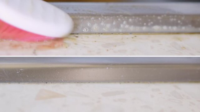 Closeup rhythmic toothbrush scrubbing along countertop seam, meditative cleaning loop near sink with pinkbristled brush and foamy suds satisfying repetitive motion removes scum