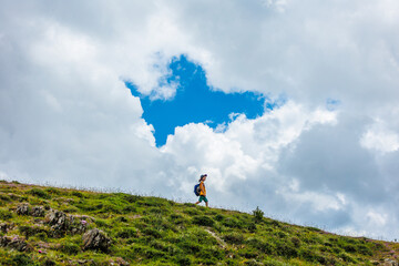 Traveling child. a tourist with a backpack walks along a mountain road. hiking and active healthy lifestyle.
