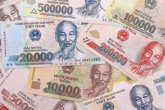 Vietnamese dong money bills pile on table. Vietnam banknotes of VND currency close up.