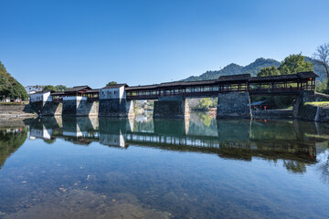 Fototapeta premium Traditional Chinese Covered Bridge Over Still River