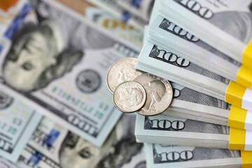 US coin lies among ten thousand dollars packs in stack on big amount of hundred dollar bills © Larysa