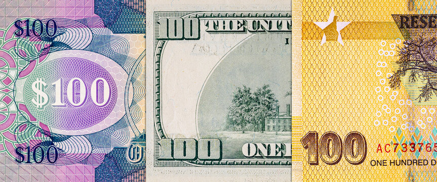 Different 100 Dollars banknotes from the USA, Guyana, and Zimbabwe. Global variety of the dollar as a monetary unit.