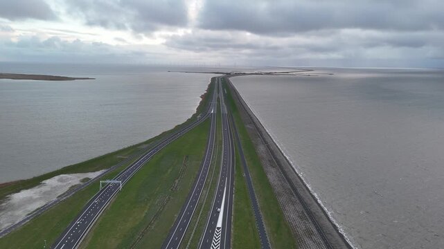 Forward aerial ride above road entering the Afsluitdijk