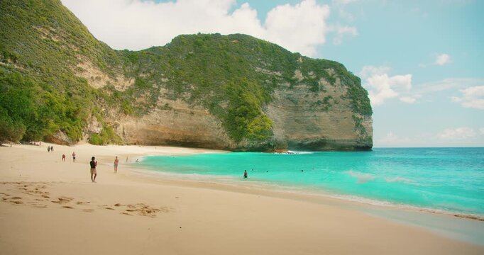 Scenic tropical white sand and rocky cliffs at Kelingking Beach Nusa Penida Bali