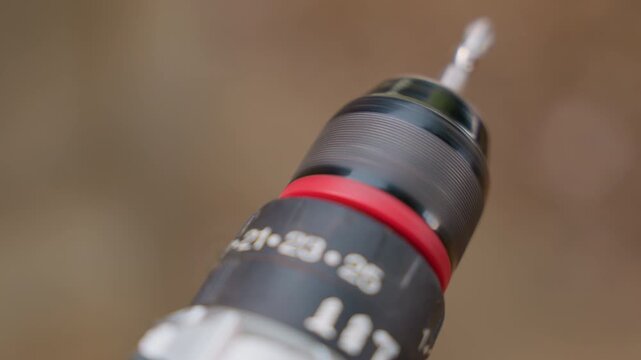 Woodworker repairing shelf utilizing cordless drill equipped with torque measurement feature. Handyman assembling shelf by employing cordless drill fitted with torque indicator for precise tightening