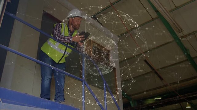 Holographic globe appearing beside mezzanine worker, raising tablet, tapping, analyzing site data