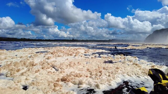 A view of Canaima Lagoon, with dense foam caused by tannins released from organic matter carried in the water from both the lagoon and the Carrao River, Venezuela