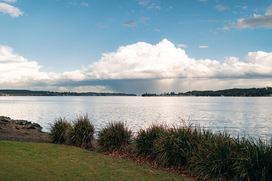 Serene lake landscape with dramatic clouds and distant shoreline at Lake Macquarie NSW