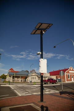 Smart pole with solar panels and cameras monitors urban intersection for safety and traffic