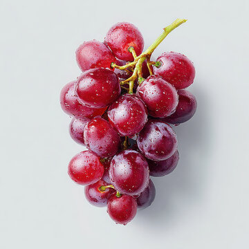 Fresh cluster of ripe red grapes covered in small water droplets on a light background
