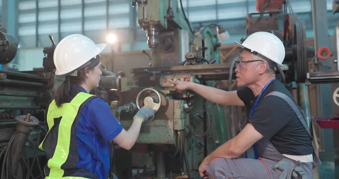 Father passes down machine know-how to his daughter in a family factory, guiding succession, workshop skills and leadership transition through hands-on manufacturing training.
