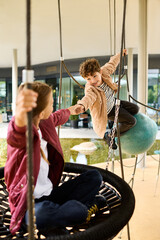 Obraz premium Playing joyfully together on swings in autumns golden glow during childhood bliss