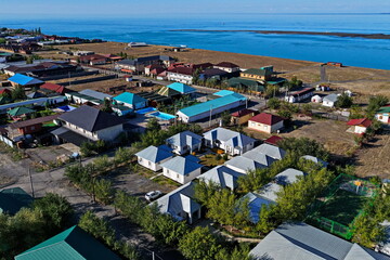 Obraz premium Almaty region, Kazakhstan - 08.25.2025 : Houses for guests and tourists in the recreation area. Hostels. Lake Alakol. Summer seasonal holidays.
