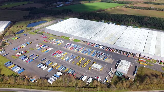 Aerial view of a vast warehouse surrounded by neatly arranged trailers, reflecting a hive of logistical activity in Worksop, England, United Kingdom.