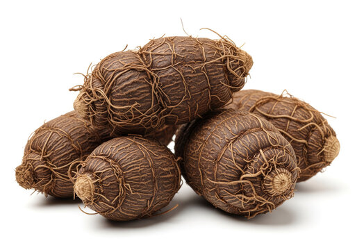 Macro photograph of a small pile of dark brown, fibrous root vegetables or tubers, isolated on a white background, showcasing natural texture and earthiness.
