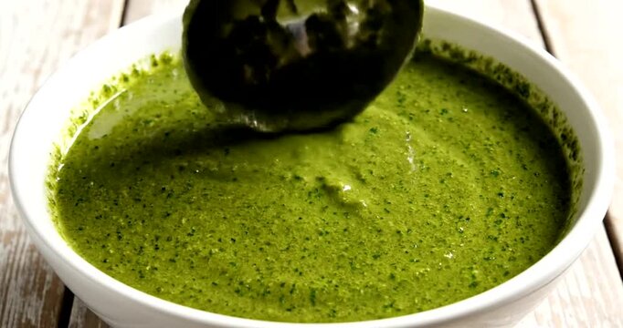 Healthy green soup in white bowl.