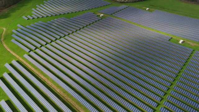 Aerial view of a vast solar panel farm, a symphony of blue and green, where technology meets nature in a quest for sustainable energy, Sherwood forest, Mansfield, United Kingdom.