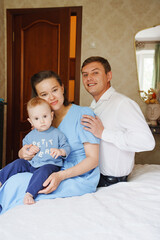 Family portrait in a cozy bedroom with a young child