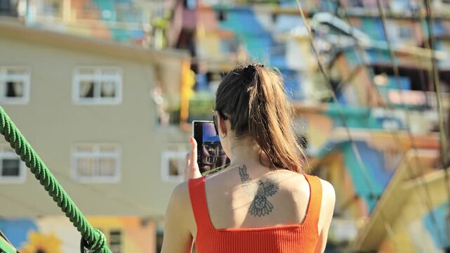 Tourist with sunglasses records Benguet hillside homes from bridge viewpoint