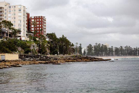 Tall residential buildings rising above the rocky coast