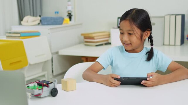 Young girl having fun working on a robot design