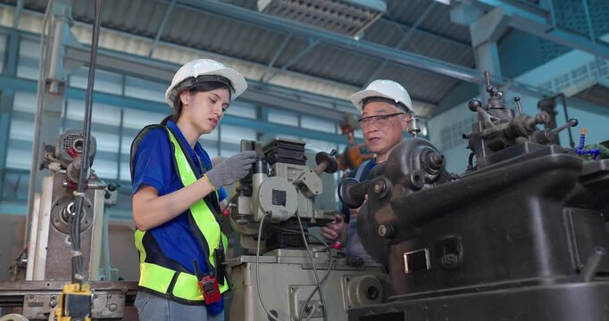 Father passes down machine know-how to his daughter in a family factory, guiding succession, workshop skills and leadership transition through hands-on manufacturing training.
