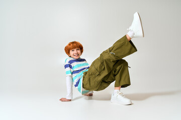 Stylish little boy showcasing his creativity and playful spirit in trendy fashion outfit © Bliss