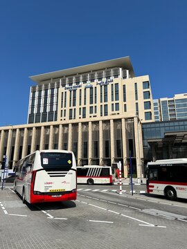 White and red Dubai RTA buses parked in front of the Days Hotel by Wyndham. Dubai, UAE. 2023.
