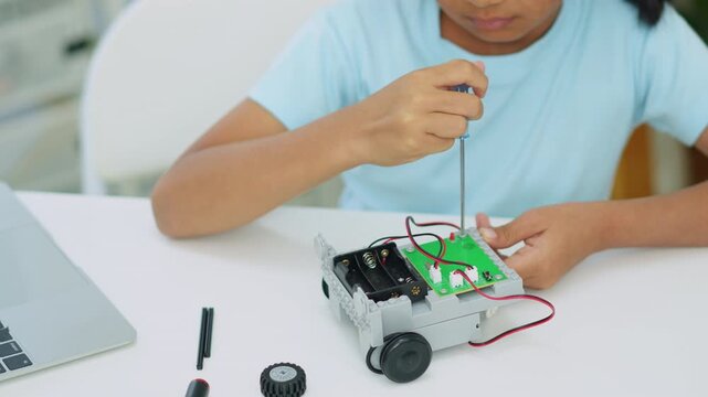 Young girl having fun working on a robot design