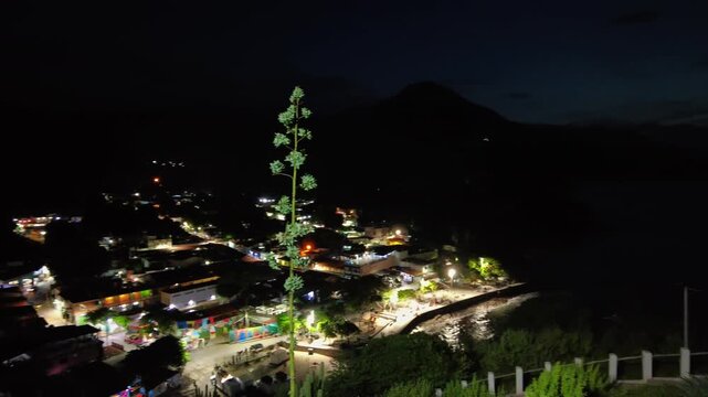 A pan shot from a high viewpoint of the village of Choroni in Aragua, Venezuela, at night, facing the boardwalk