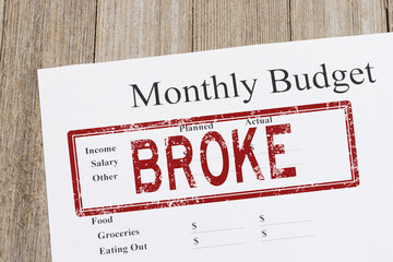 Monthly budget with broke stamp for financial crisis