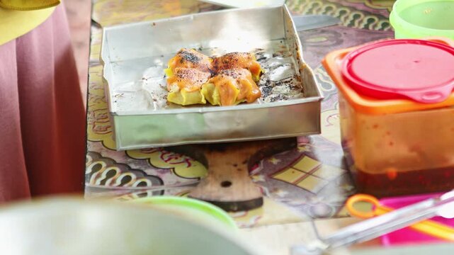 Street vendor grilling tasty dimsum dumplings