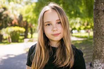 Obraz premium Beautiful child looking at camera outdoors. Beautiful girl portrait