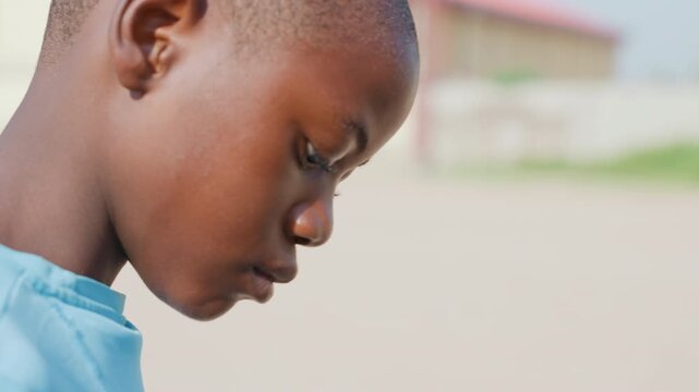 Focused boy preparing for exercise. Young boy athlete in stance with focused attention before workout. Profile of male youth athlete concentrating intensely prior to physical training session