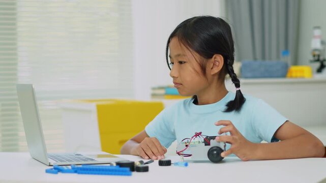Young girl having fun working on a robot design