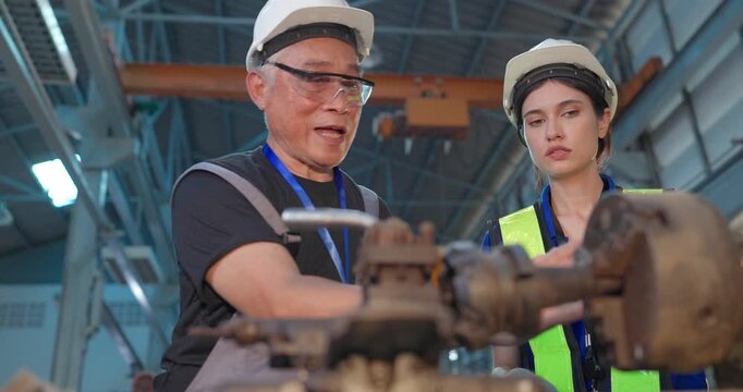 Entrepreneur explains custom DIY workpiece requirements to an engineer, reviewing parts, design options and prototype specifications in a workshop during development planning.
