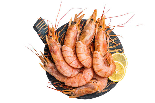 Ready for cooking Red Argentine shrimps, raw Prawns Langostino Austral on wooden board isolated on white background. top view
