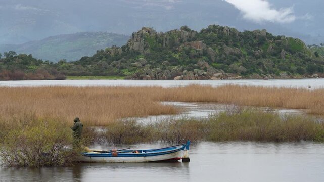 Traditional Wooden Fishing Boat Moored in the Reeds of Bafa Lake, Turkey. High quality 4k footage