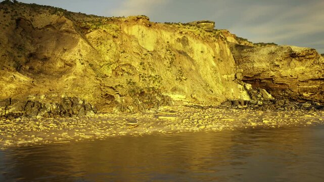 luxury retreat cliffside vista with golden light and calm sea, premium travel backdrop suggesting exclusivity and serenity, ideal for hospitality and lifestyle