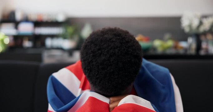 Face, black man and uk flag for sports at house for missed score, match loss and team losing. Sad, person and watching tv for soccer game, penalty reaction and live streaming for football tournament